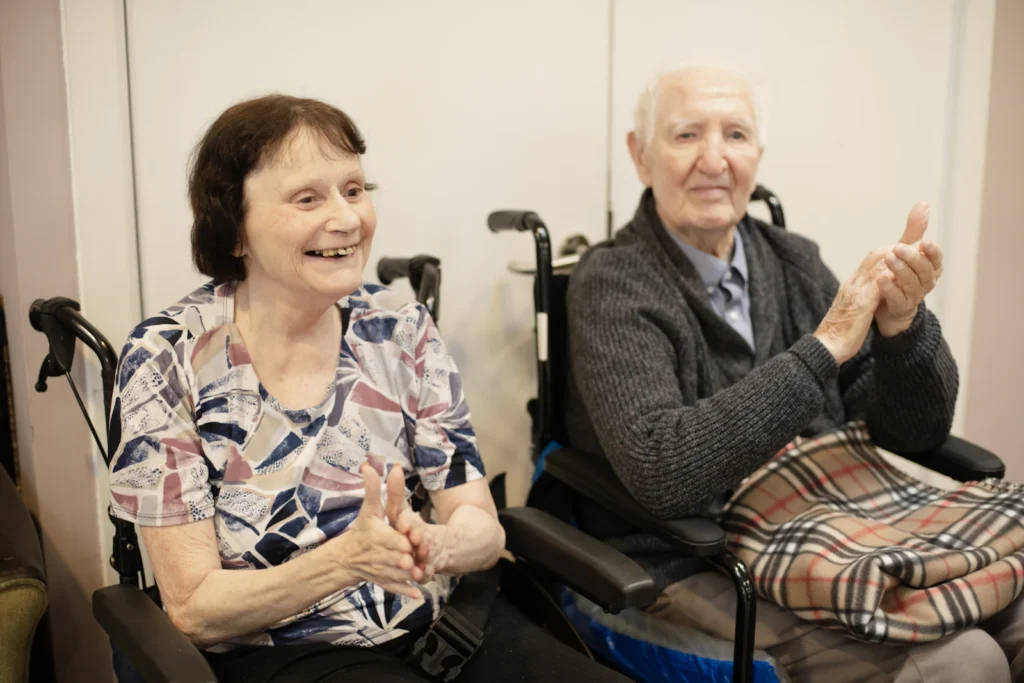 Senior couple clapping during a group activity