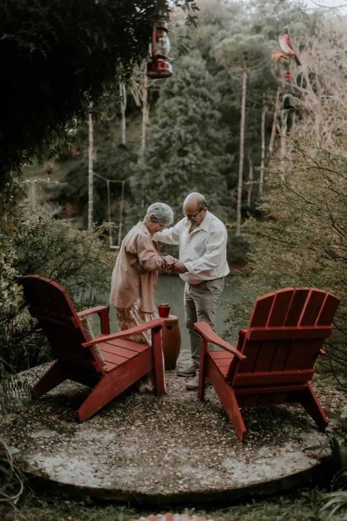 Senior couple relaxing in garden chairs