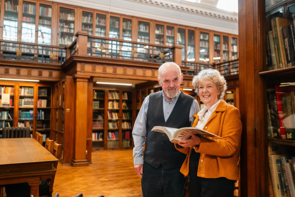 Senior couple reading together in a library