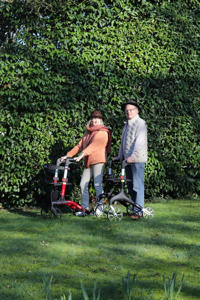 Senior couple with rollators in the garden