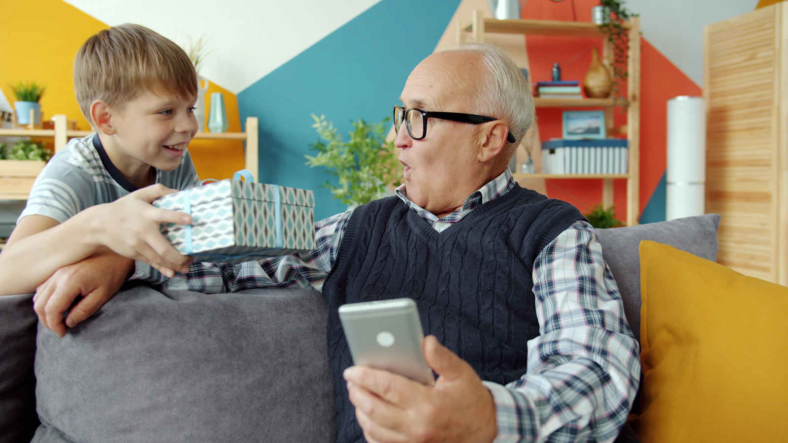Grandfather and grandson sharing a phone