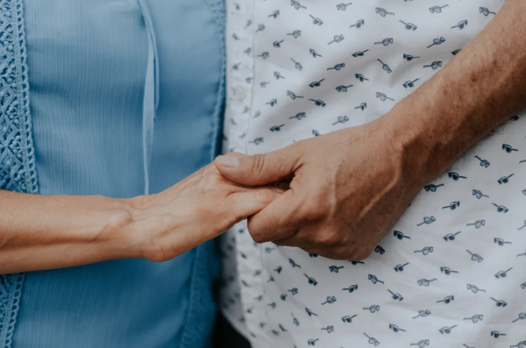 Close-up of two people holding hands