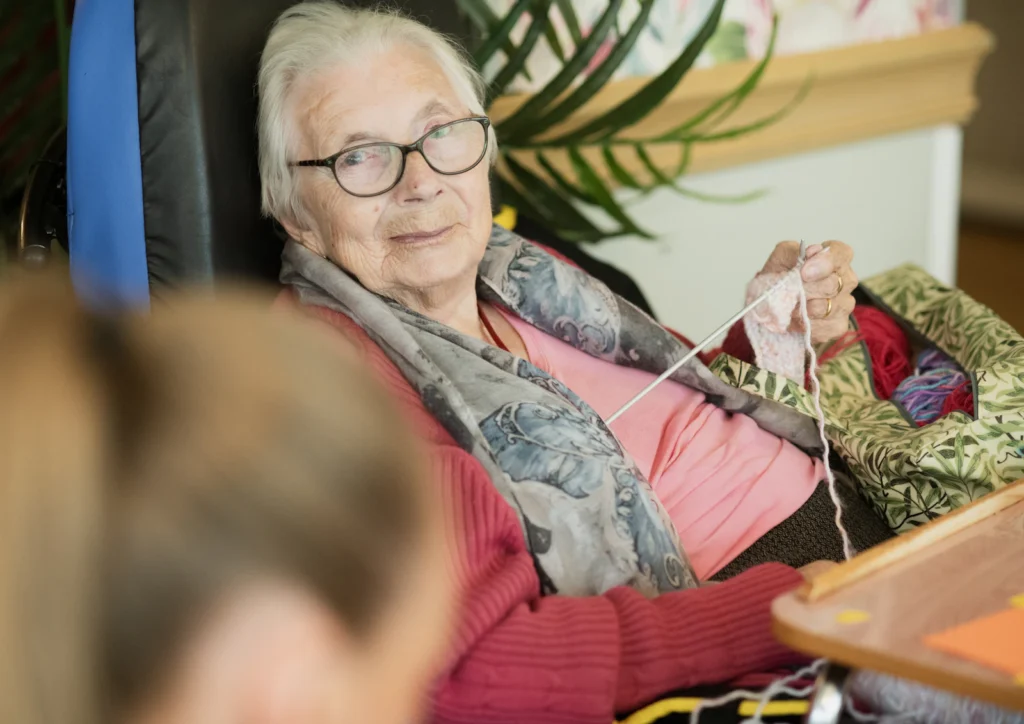 Senior woman with glasses sitting in an armchair
