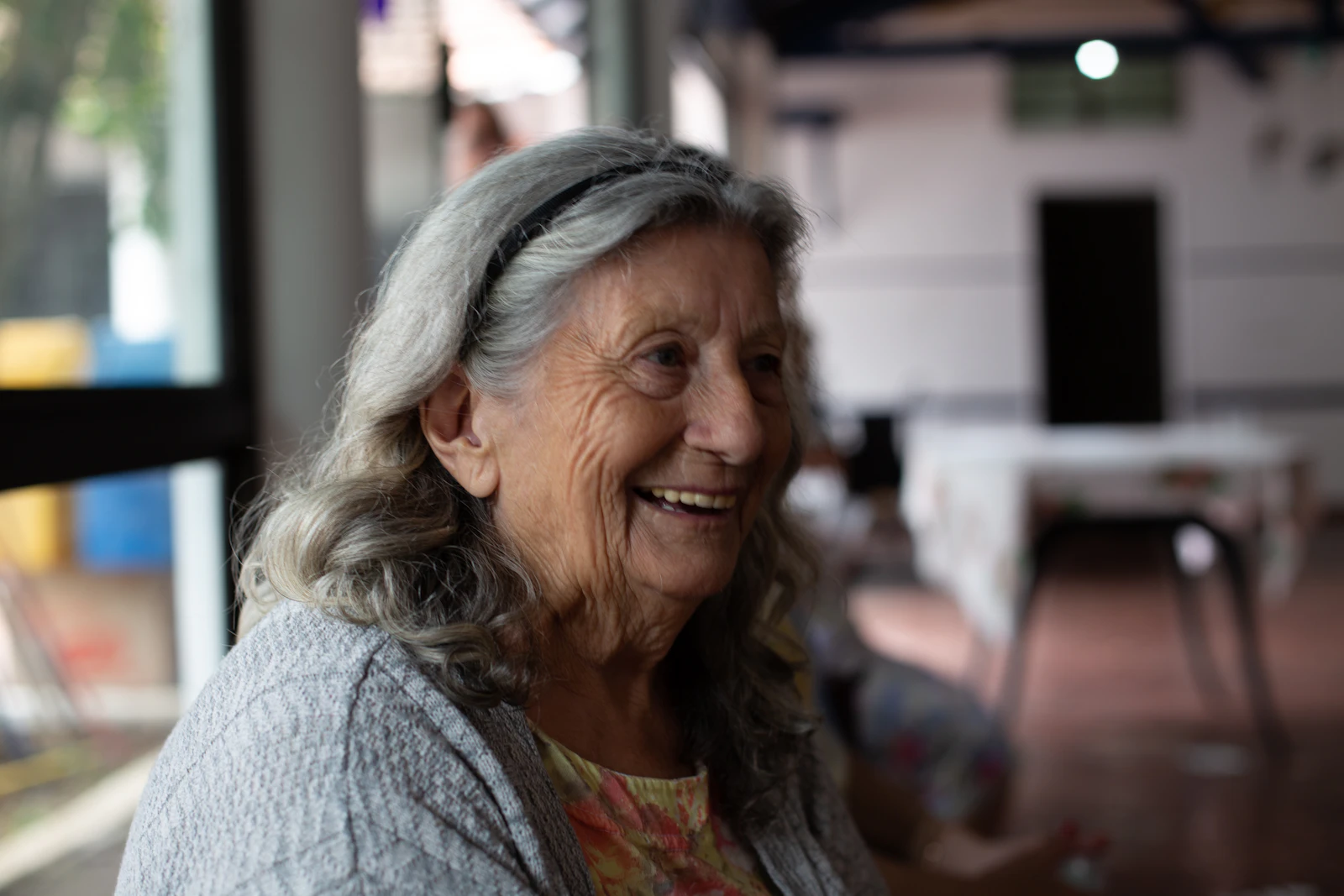 Senior woman laughing by a window