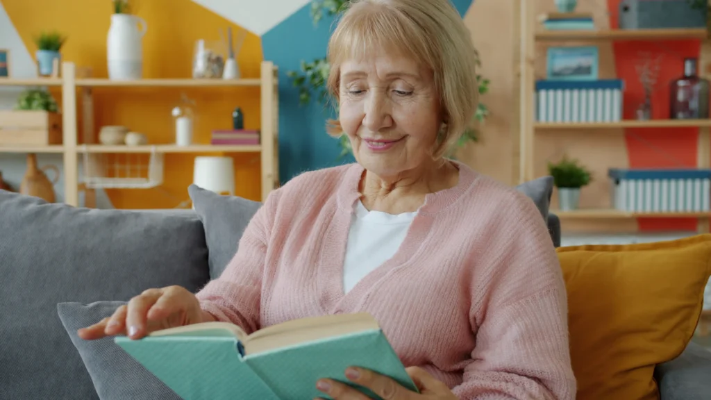Senior woman reading in an armchair