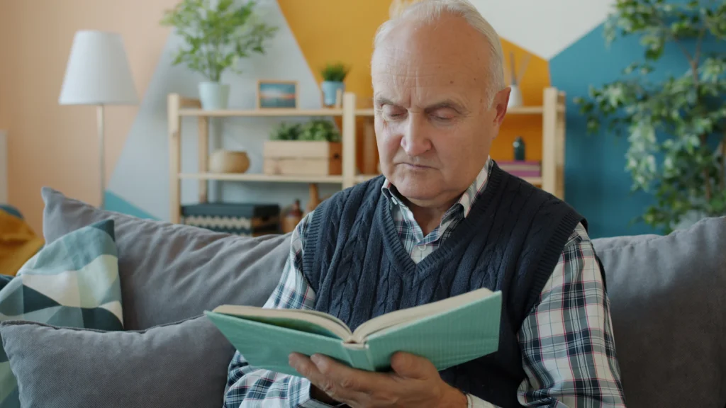 Senior man reading on the couch