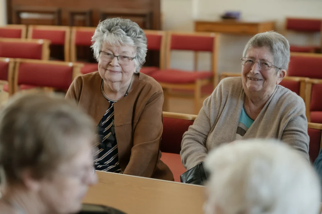 Senior residents laughing at a table